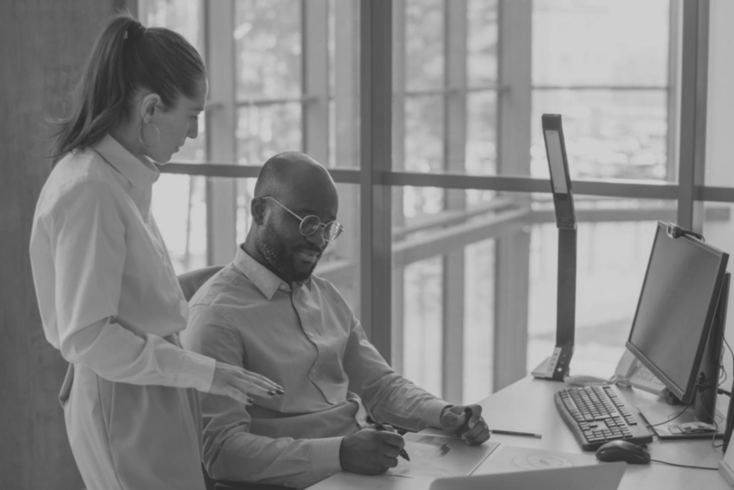 Professional financial analysis workspace with computer displaying financial charts and reports